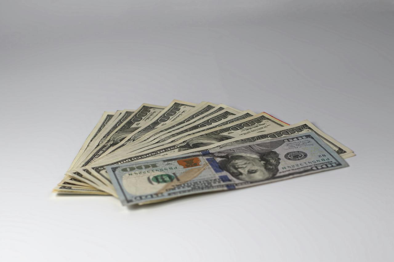 a stack of twenty dollar bills laying on top of each other